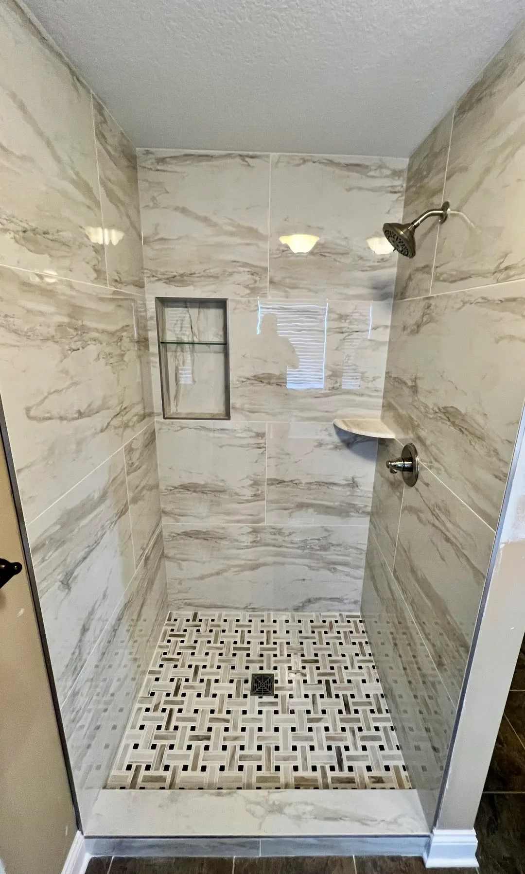 Rebuilt walk-in tiled shower with large-format wall tile and epoxy grout joints